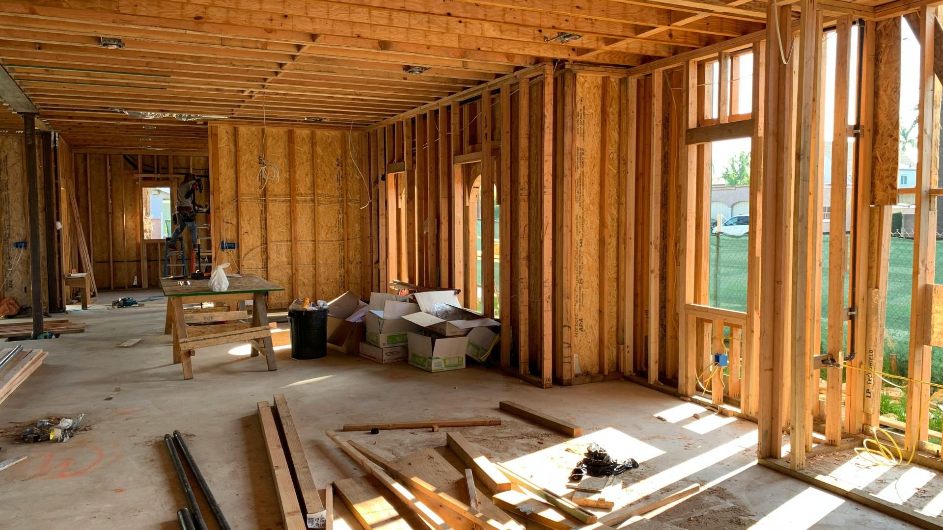 Interior of a house under construction with wooden frame and construction materials